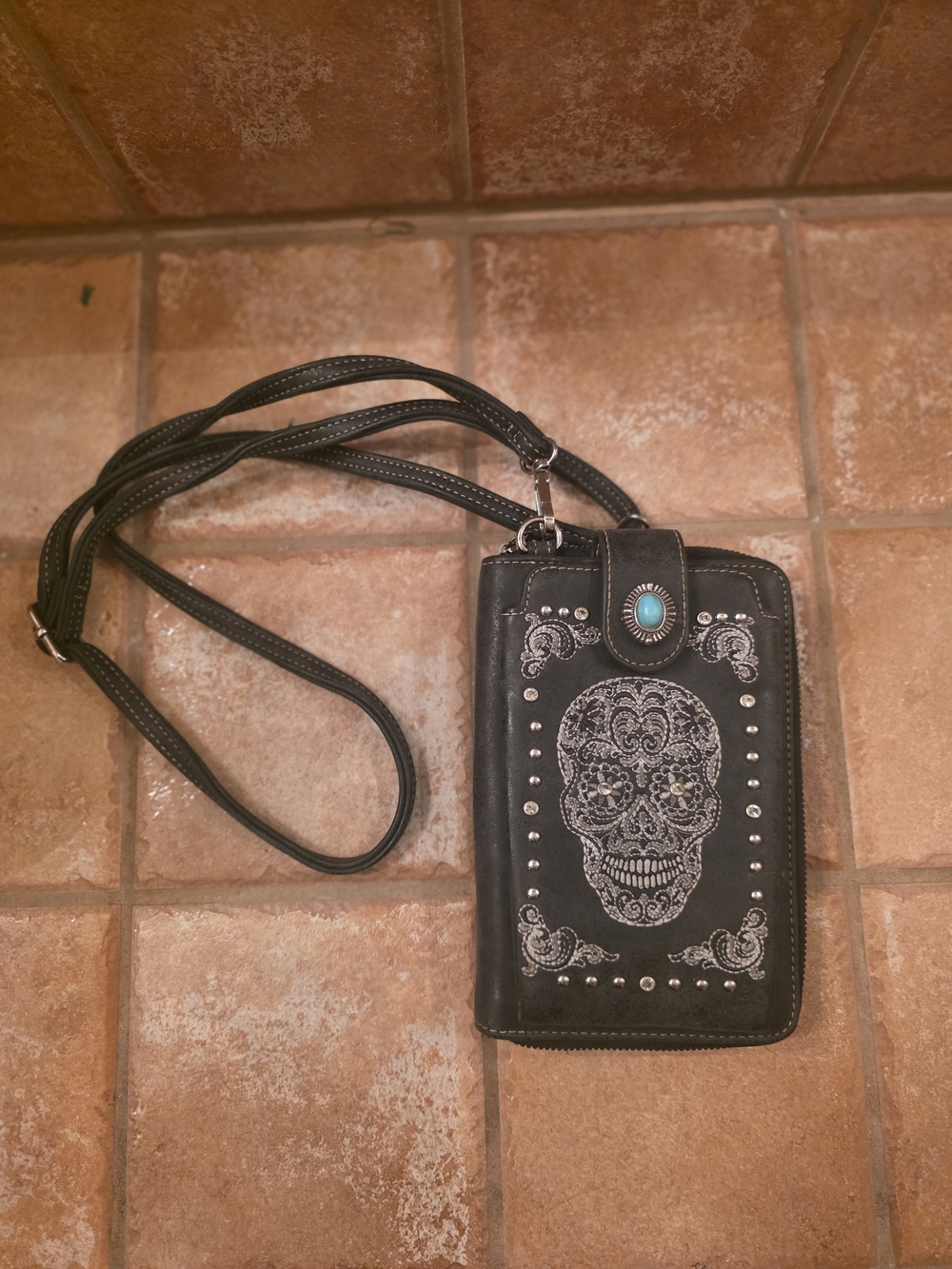 Black Crossbody Phone Wallet with Decorative Skull and Turquoise Accent